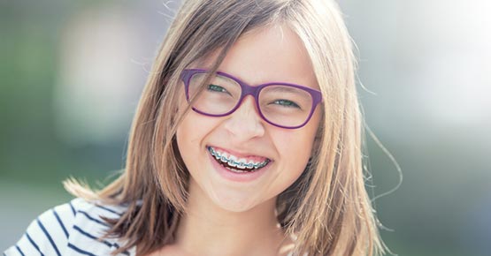 attractive teen female with braces, smiling.